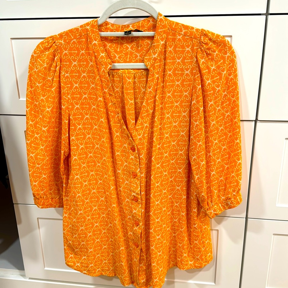 Dora Landa orange top